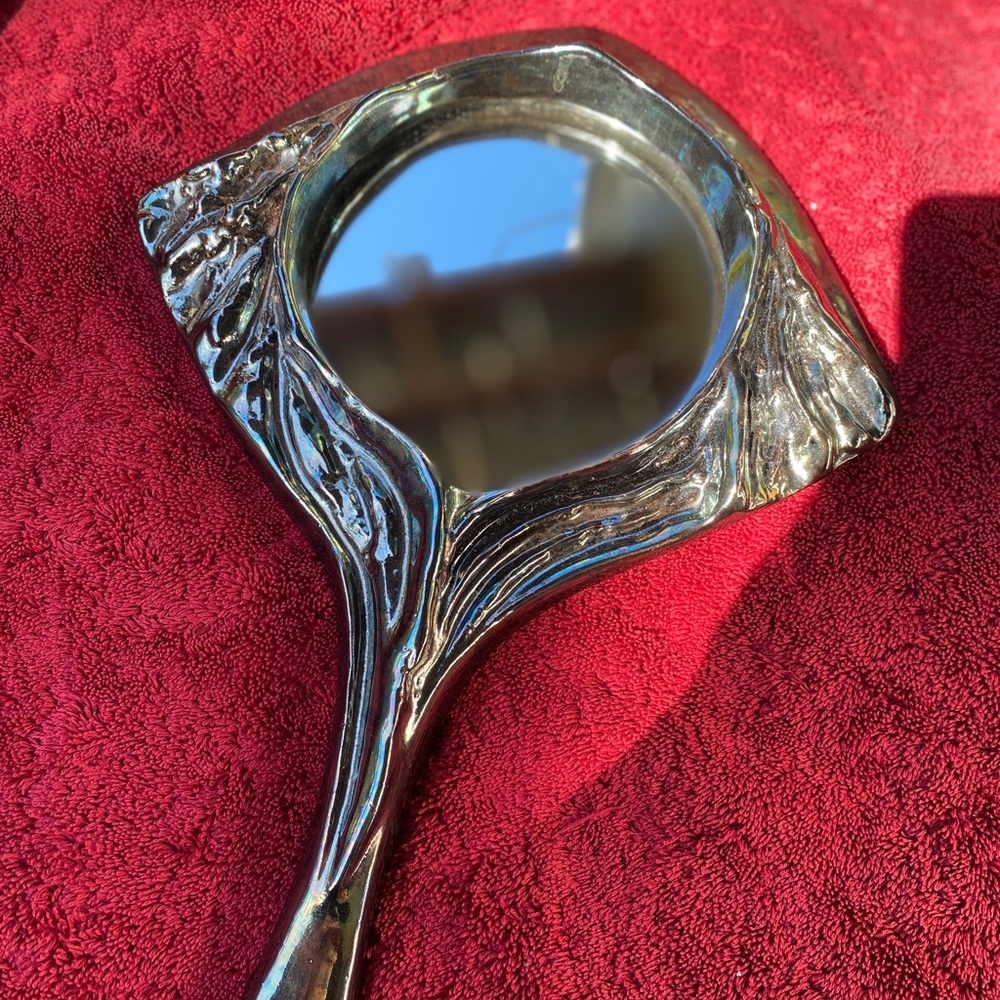 Metallic fired ceramic hand mirror